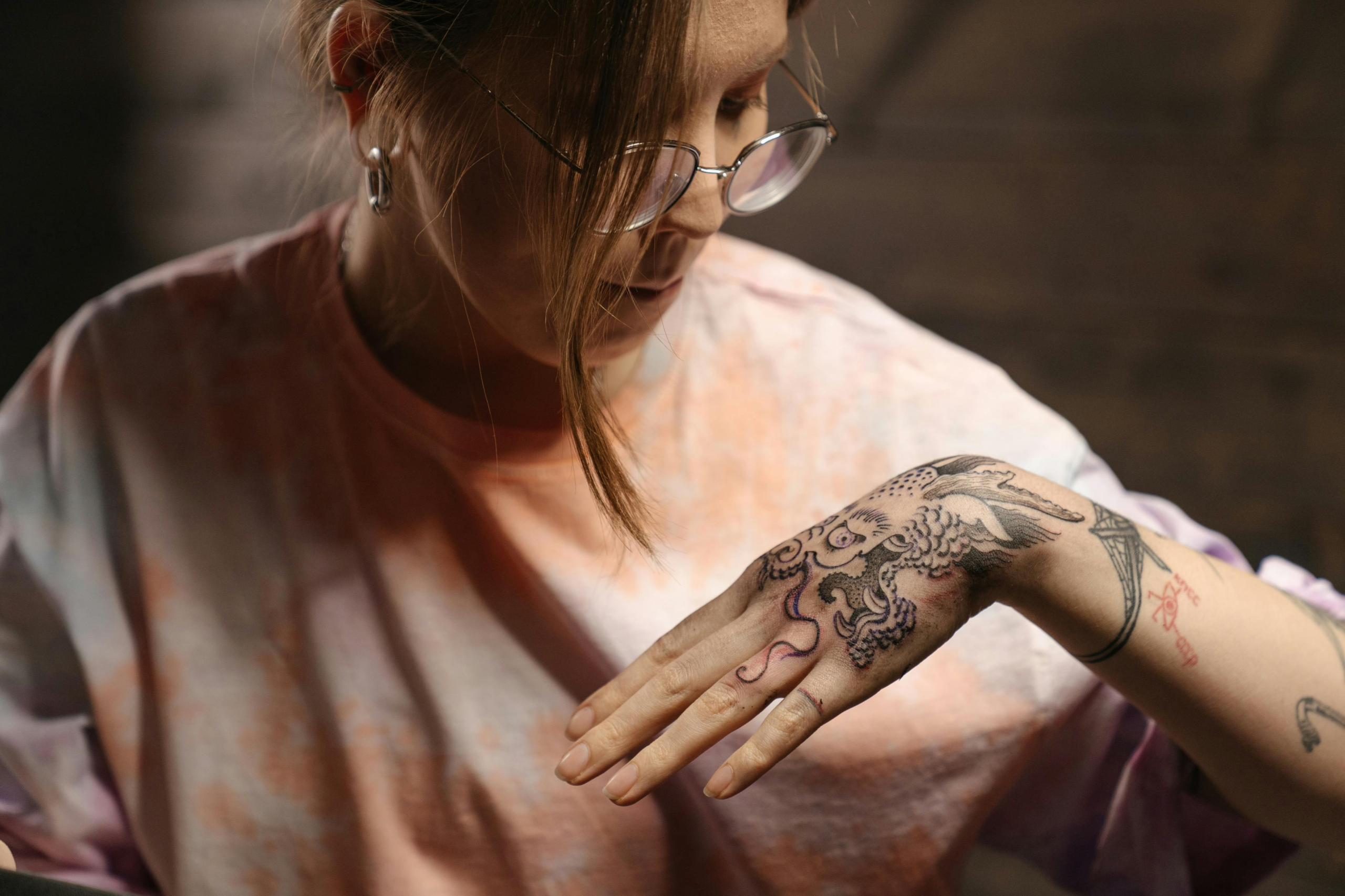 Tattoo artist photographing a freshly completed tattoo in their studio