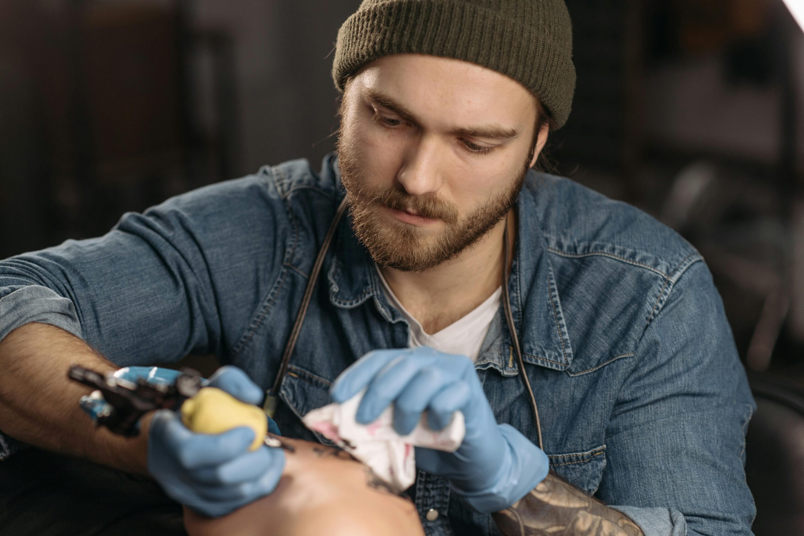 Tattoo artist working on a client in a local tattoo studio