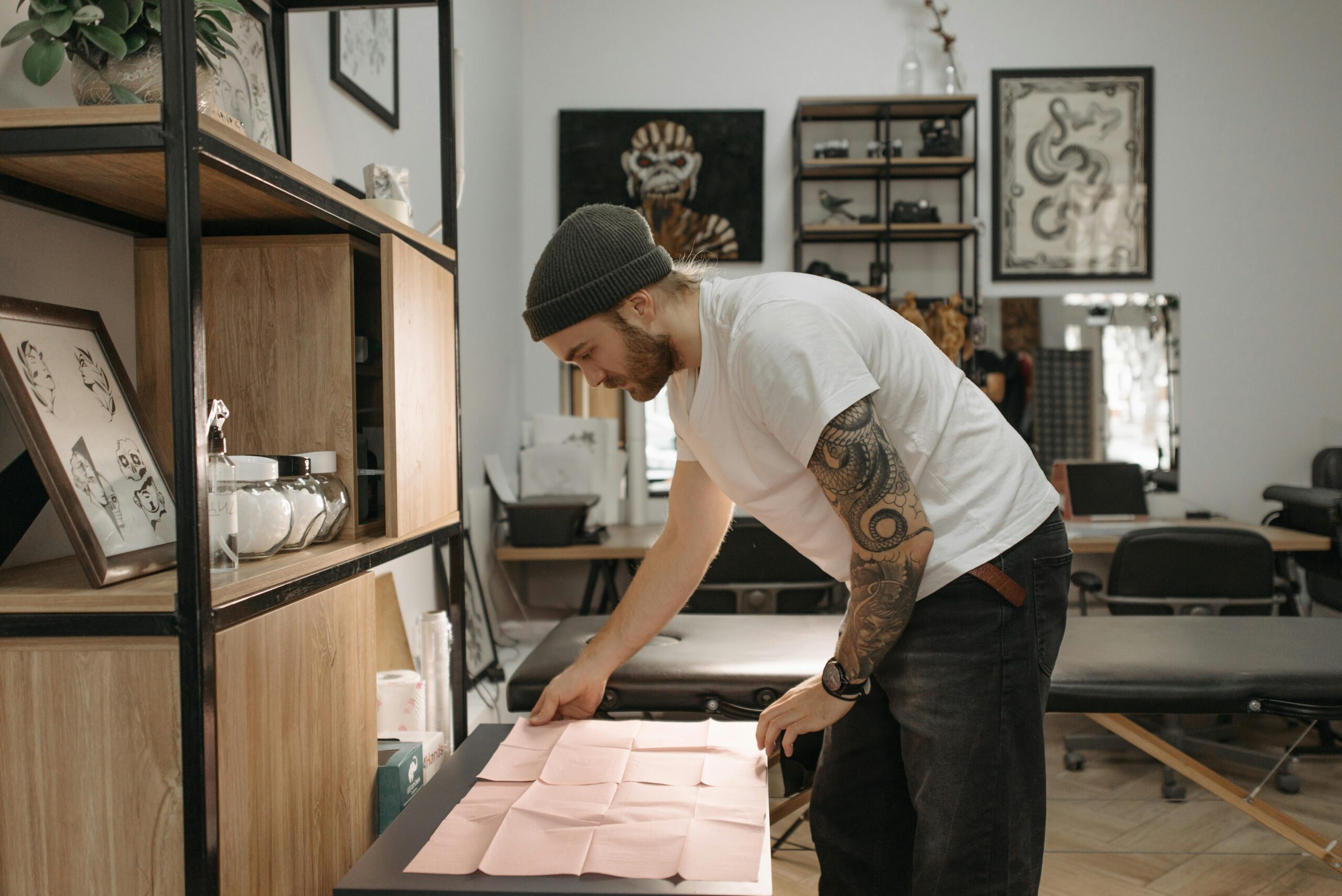 Tattoo artist working on social media content in their studio to attract clients